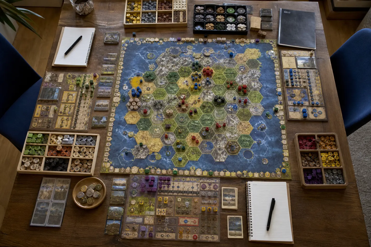 Large strategy board game setup with player boards, sorted resources, and many components spread across a wide table.